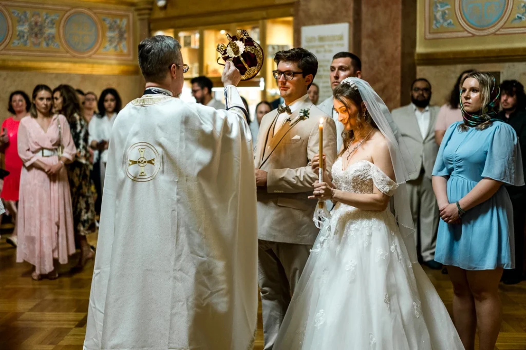 Bride and groom and priest are looking at each other Wedding Photography at St. Nicholas Russian Orthodox Cathedral