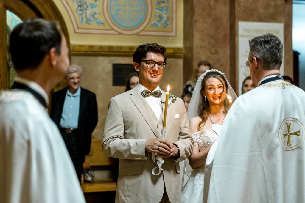 Bright room, smiling while holding candles Wedding Photography at St. Nicholas Russian Orthodox Cathedral