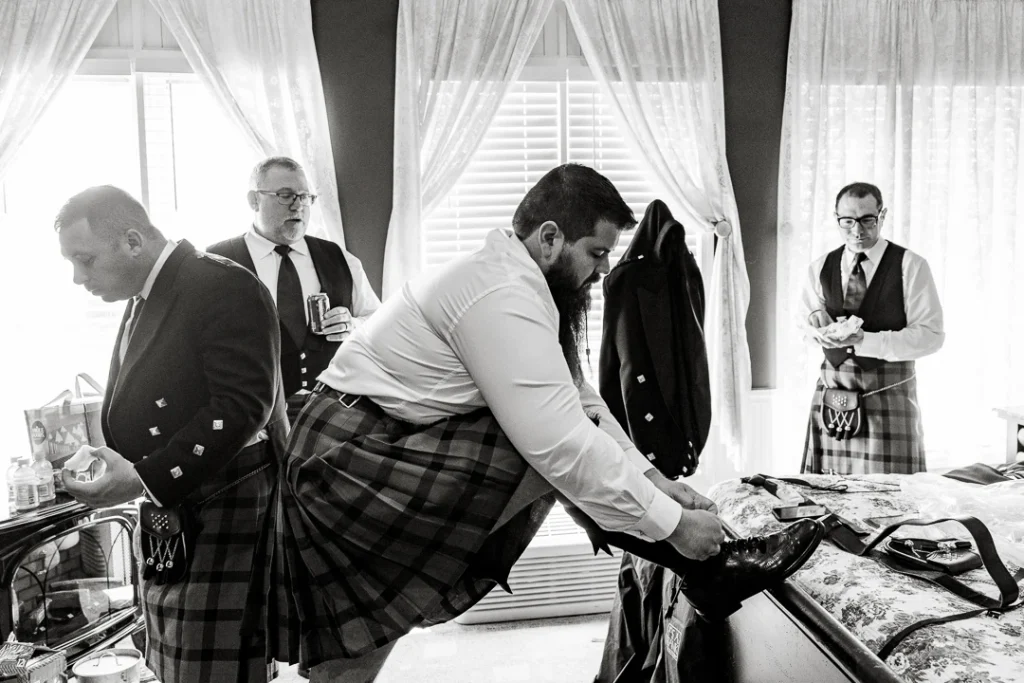 Groom getting dressed at the Smithville Inn Wedding photography