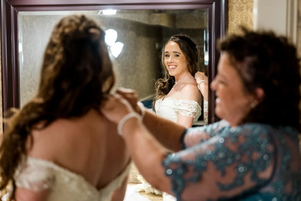 Bride and Mom getting dressed before ceremony at the Smithville Inn Wedding photography