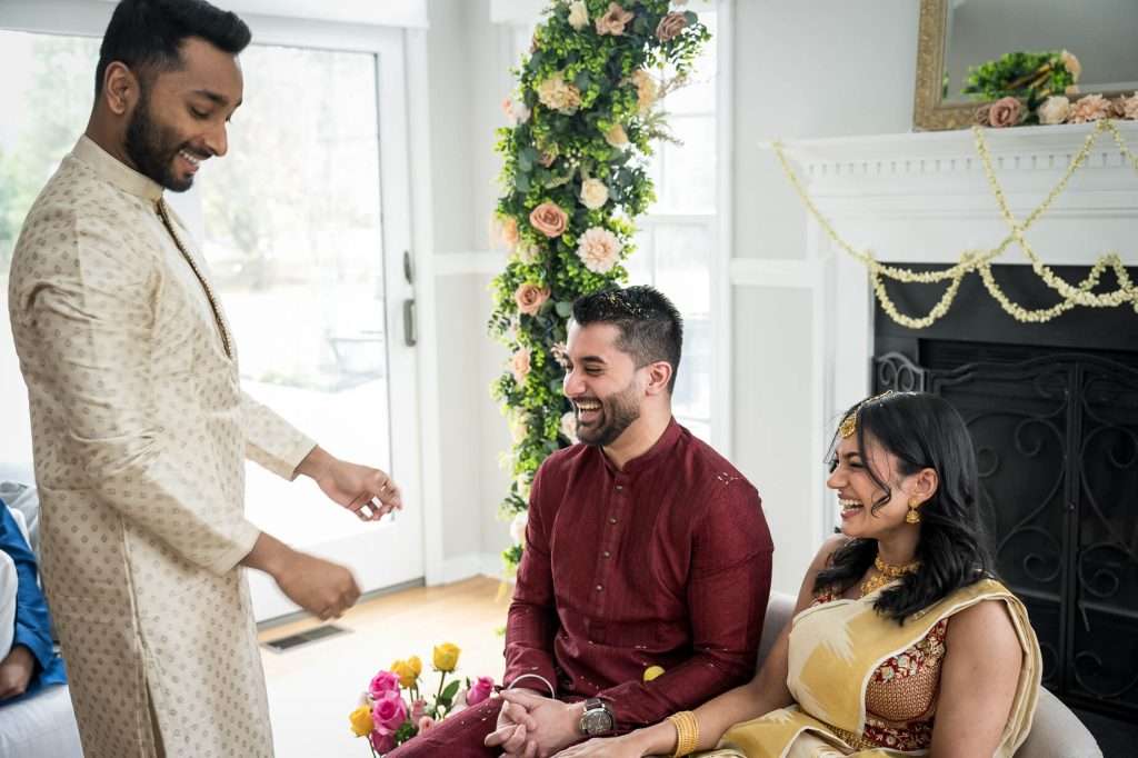 Joyful Greetings: Family members interacting warmly, with smiles and traditional attire, emphasizing the celebratory atmosphere.