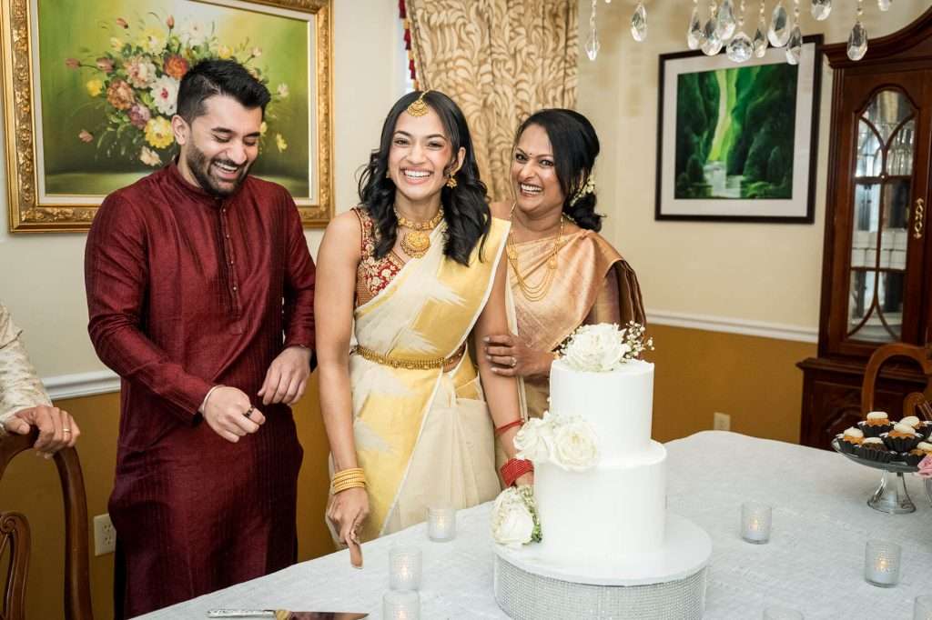 Laughter fills the air as the family gathers around the engagement cake, a moment of pure happiness and familial warmth during the celebration.