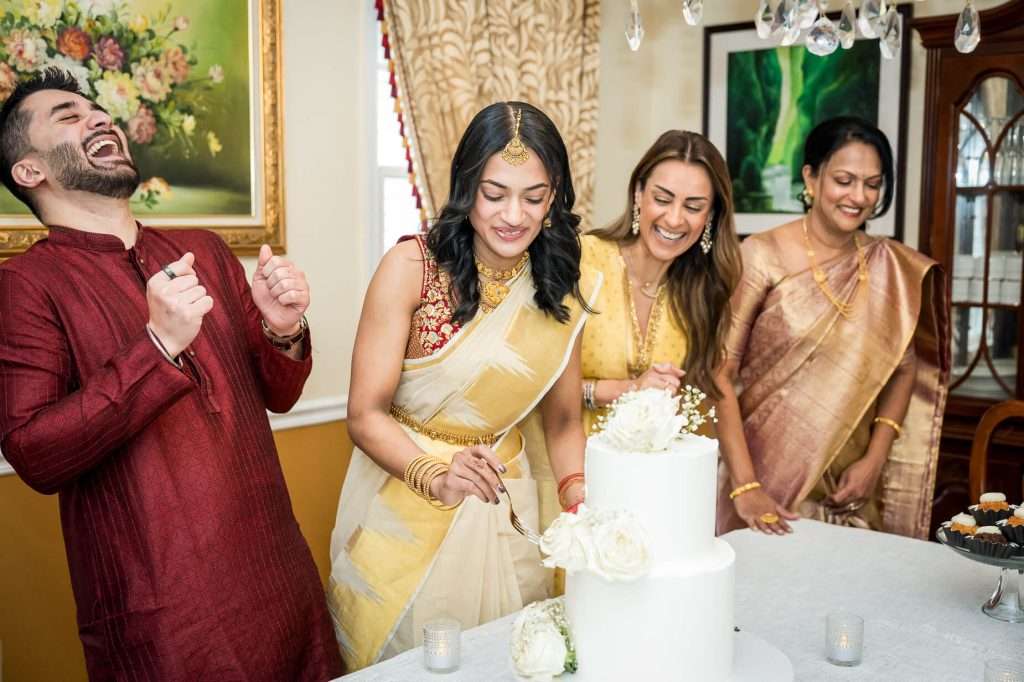 Cutting the cake becomes a cheerful celebration of love, with smiles and laughter shared by all, highlighting the joyous atmosphere of the engagement.