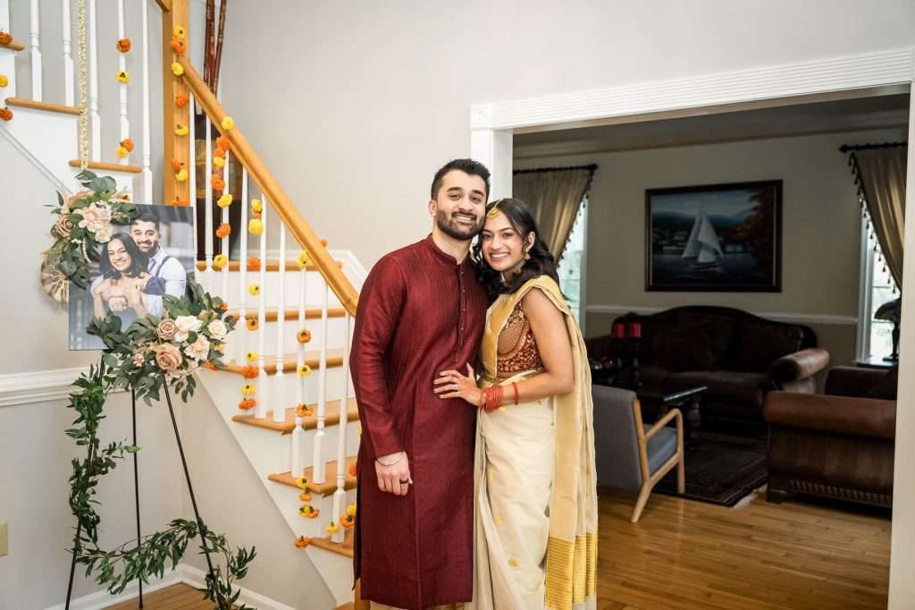 A cozy and intimate moment at home, this couple’s engagement is marked with personal touches and floral decorations that add a festive warmth to their special day.