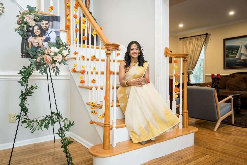 Heritage and Happiness: The bride’s infectious smile and traditional attire are highlighted against a backdrop rich with cultural significance.