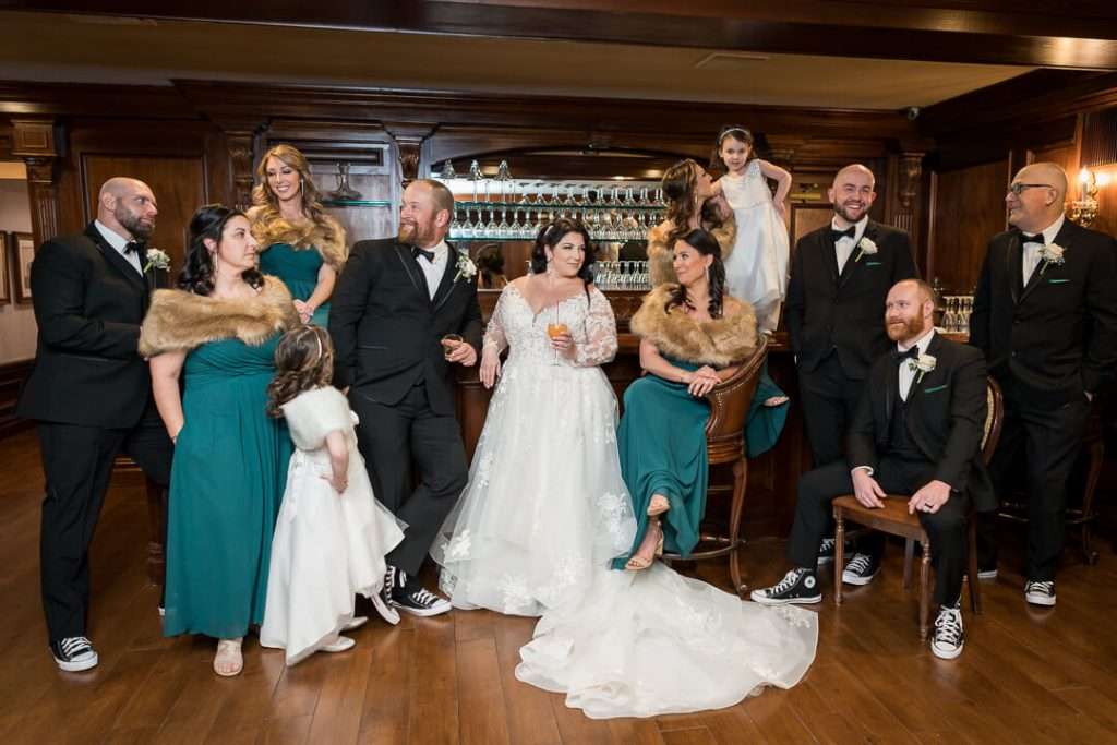 A lively and candid moment of the wedding party at The Park Savoy Estate bar, with laughter and interaction showcasing the joyful atmosphere.