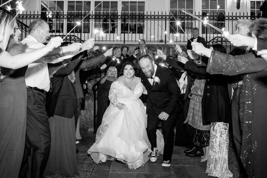 Bride and groom make a joyful grand exit at The Park Savoy, walking through a dazzling tunnel of sparklers held by cheering guests.