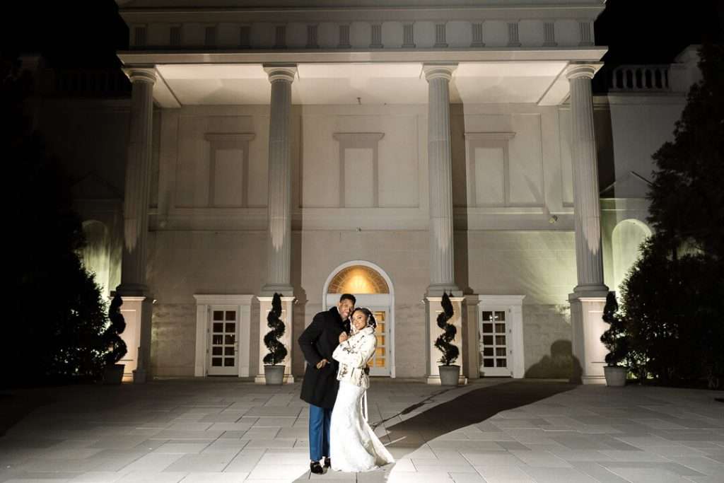 Classic wedding couple portrait at The Palace at Somerset Park – The bride and groom embrace under the grand columns of the venue, highlighting its regal ambiance.