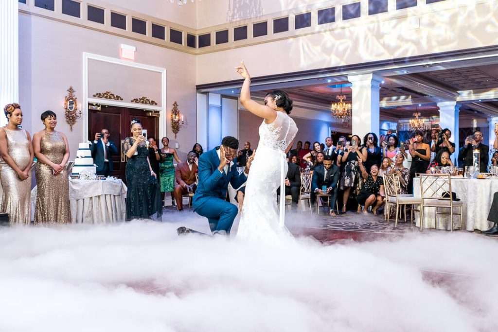First dance with fog effect at The Palace at Somerset Park – A cinematic moment from the couple’s first dance, surrounded by a dreamy cloud-like effect and cheering guests.