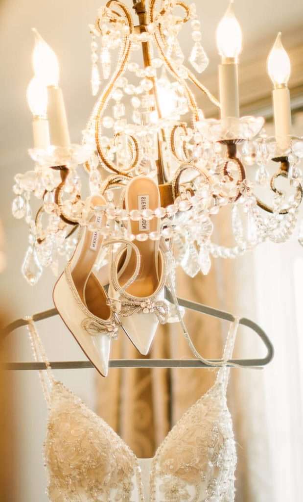 Bridal shoes hanging on a chandelier at Park Savoy wedding