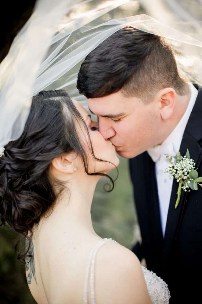 Bride and groom share a soft embrace surrounded by nature at Park Savoy