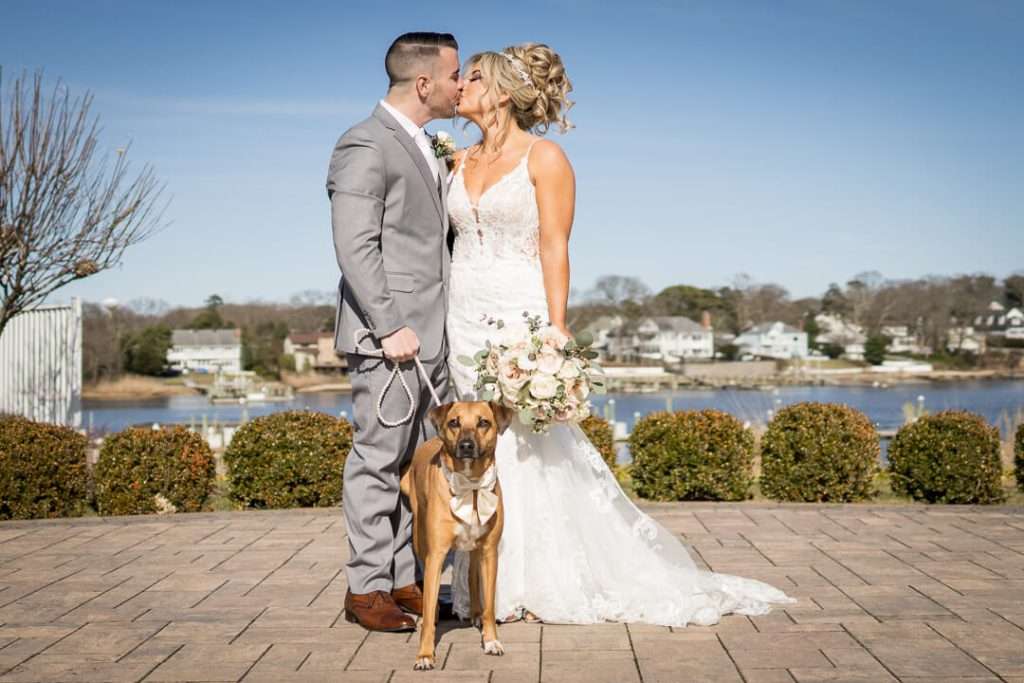 17-Crystal-Point-Yacht-Club-Bride-Groom-Kissing-with-Dog-09823