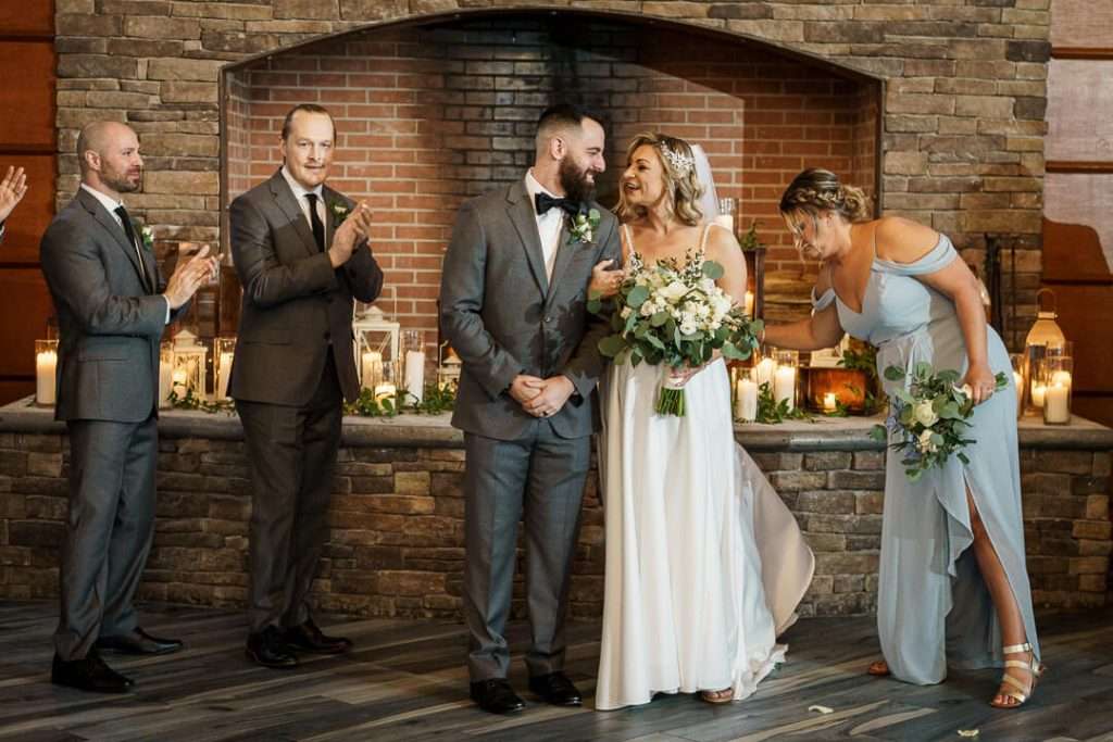 Bride and groom smiling joyfully at each other after the ceremony, surrounded by friends at Stone House at Stirling Ridge