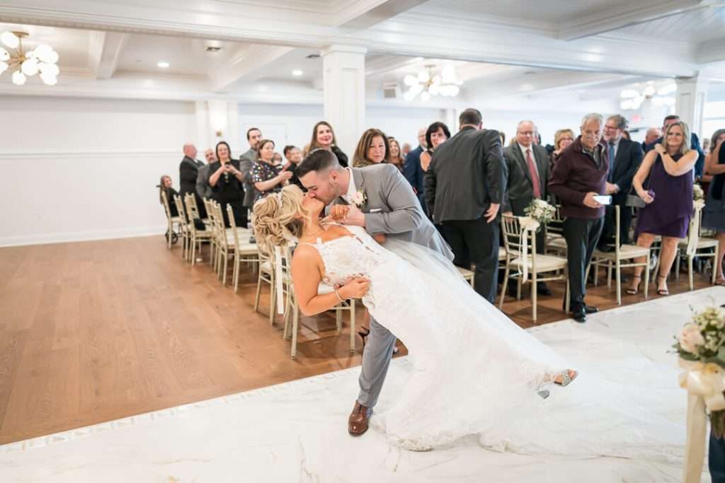 35-CrystalYachtClub-Newlyweds-Dip-Kiss-Aisle