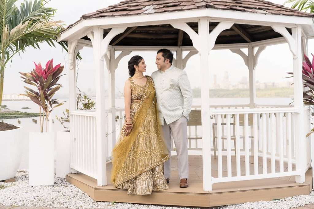 Bride and groom smiling during outdoor portrait session at Waterside Restaurant in North Bergen NJ with NYC skyline in background