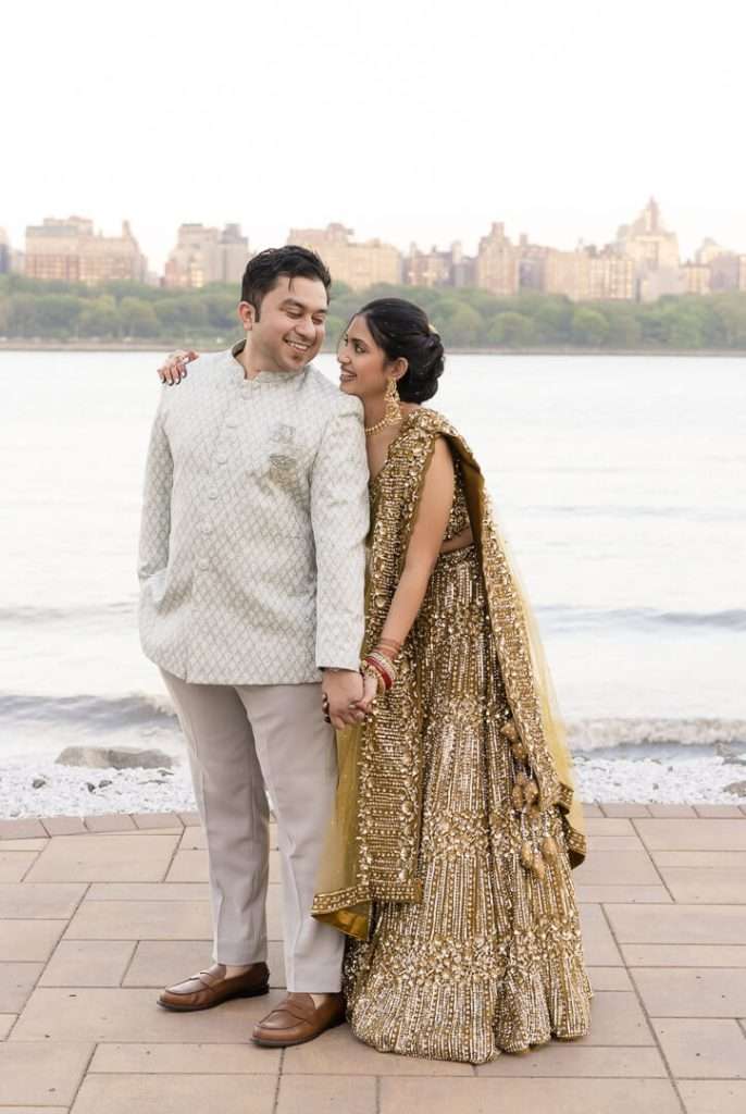 Bride and groom holding hands and smiling outdoors at Waterside Restaurant wedding celebration