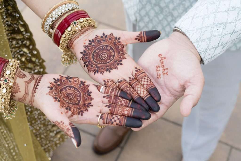 Close-up of bride’s mehndi with wedding date shown during Waterside Restaurant Indian wedding reception