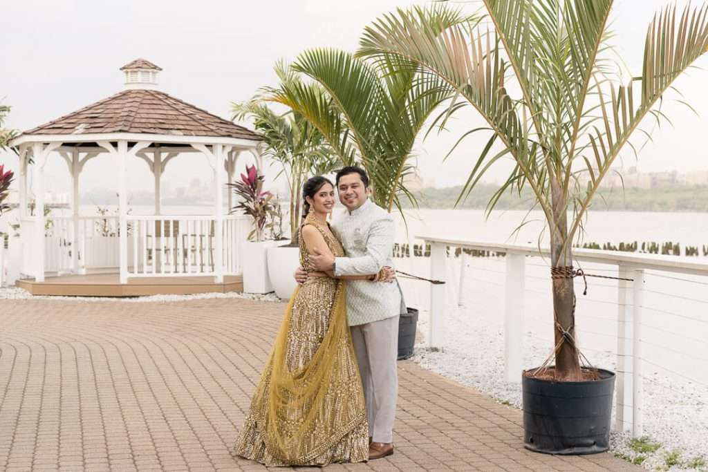 Bride and groom sharing a joyful moment in traditional Indian attire at North Bergen wedding venue Waterside Restaurant