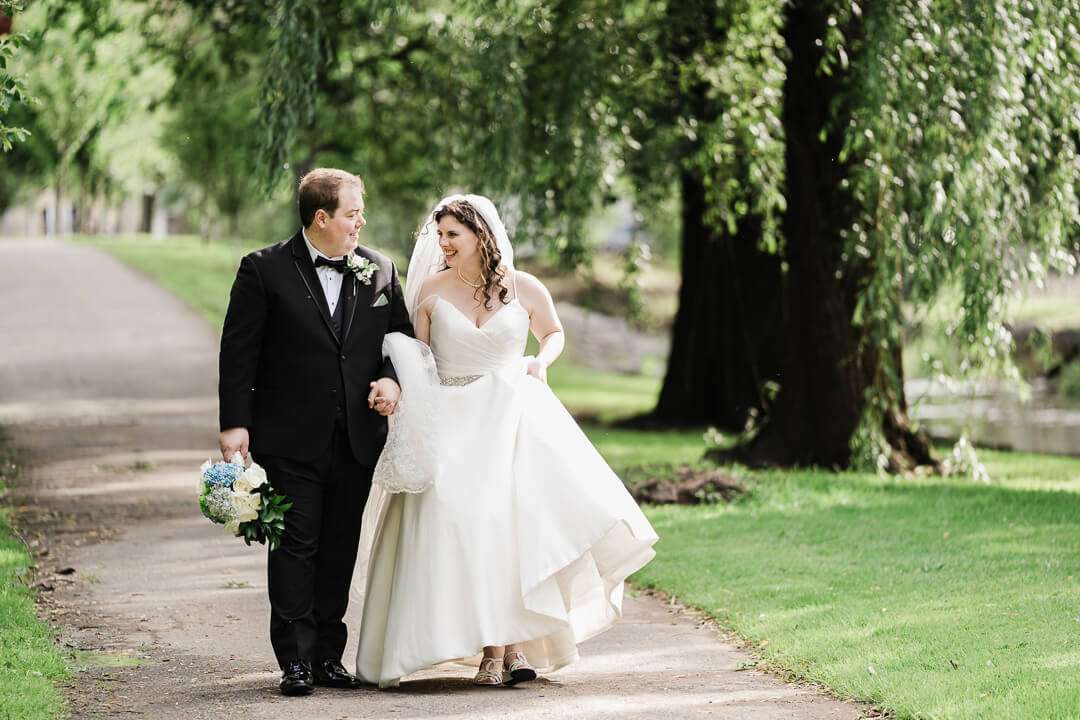 Bride and Groom Waling in park looking at each other smiling in Nutley NJ park