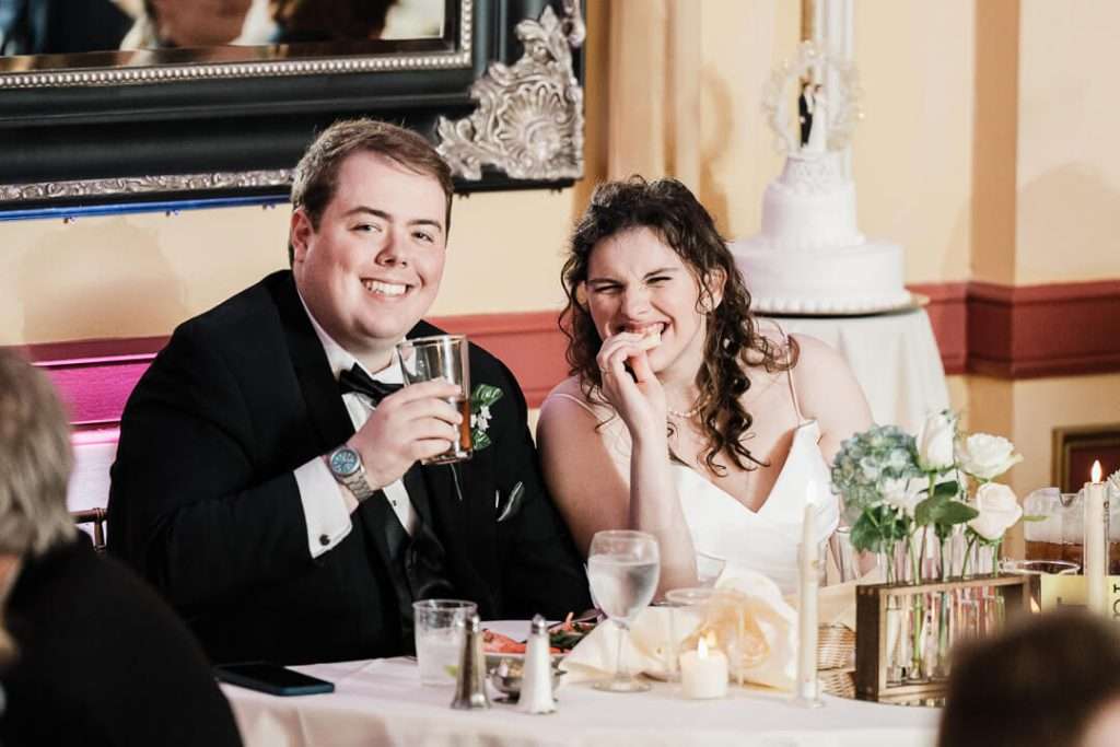 Bride and groom laughing together during reception dinner and toast in Nutley, NJ