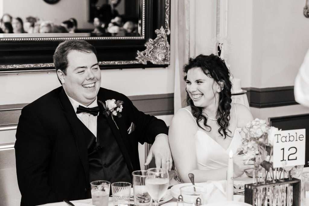 Bride and groom smiling and laughing during heartfelt toast at North Jersey wedding reception