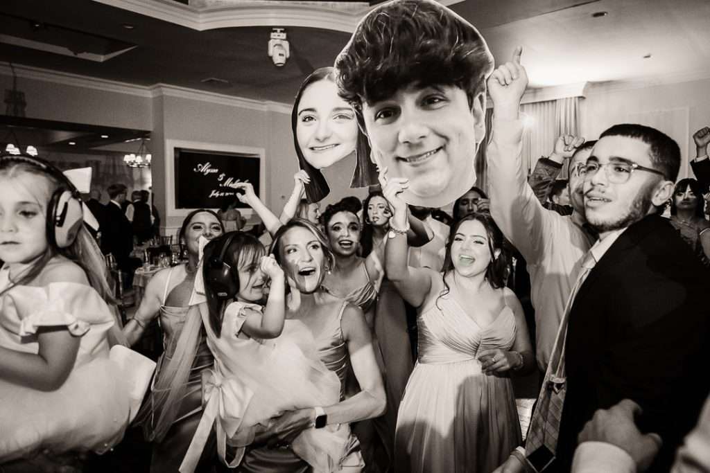 Bride and groom holding hands and smiling during wedding dance at The Mansion at Mountain Lakes