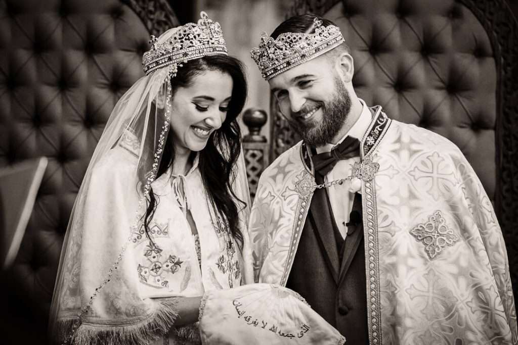 Coptic bride and groom crowned and smiling during Orthodox wedding in New Jersey