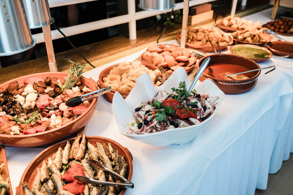 Buffet display with gourmet Mediterranean dishes, grilled meats, breads, and sauces beautifully presented during an engagement celebration at The Armory NJ Restaurant in Perth Amboy, captured by Alex Kaplan Photography.