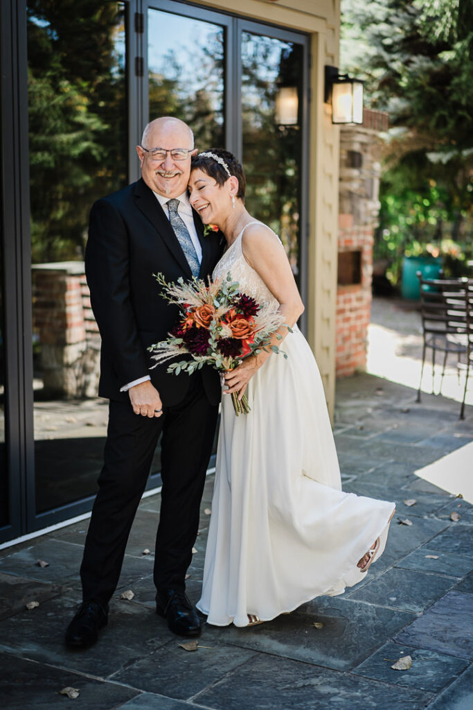 Emotional portrait of the bride and her father outside Mohawk House, smiling together before the ceremony.