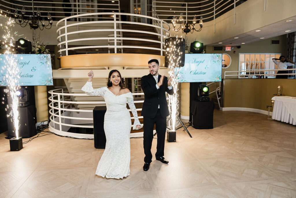 Couple making a joyful grand entrance with sparklers at The Armory NJ Restaurant in Perth Amboy, photographed by Alex Kaplan Photography.