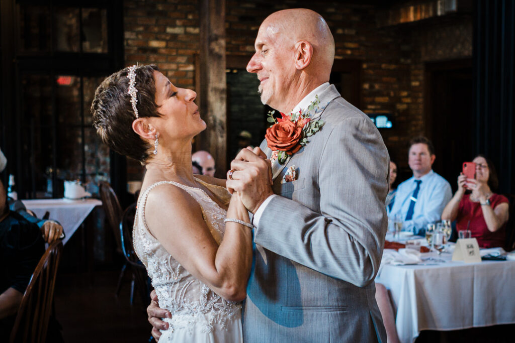Bride and groom sharing their first dance surrounded by family and friends inside Mohawk House in Sparta NJ.