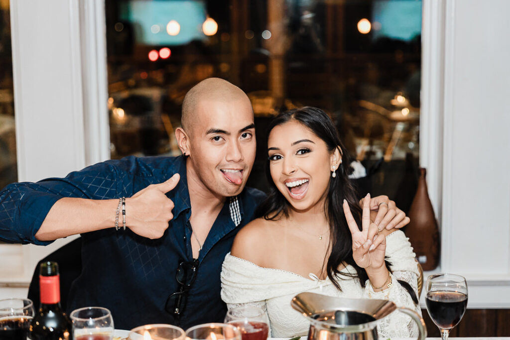 Guests laughing and posing playfully during dinner reception at The Armory NJ Restaurant in Perth Amboy, photographed by Alex Kaplan Photography.