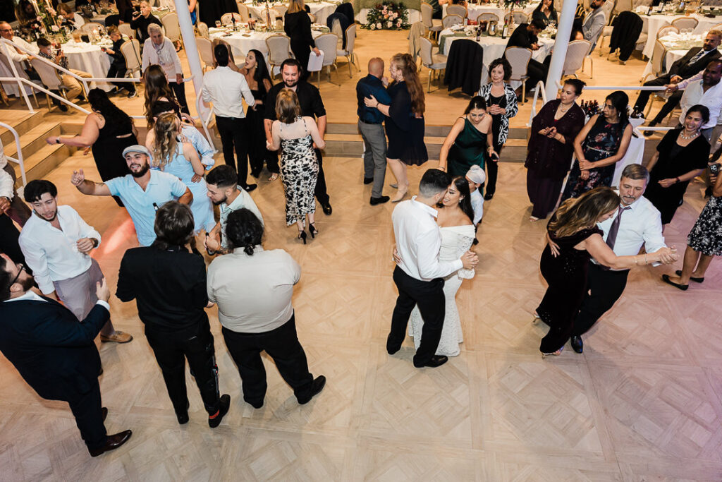Guests dancing and celebrating during the wedding reception at The Armory NJ Restaurant in Perth Amboy, photographed by Alex Kaplan Photography.