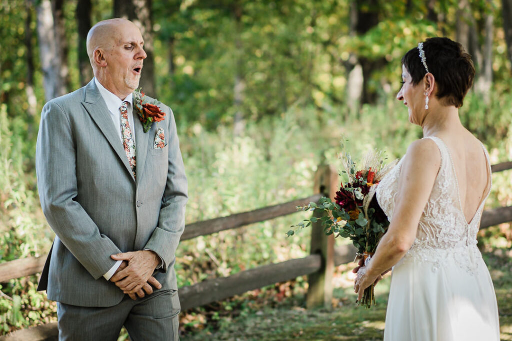 Groom reacting emotionally during the first look at Mohawk House, seeing his bride for the first time in the fall sunlight.