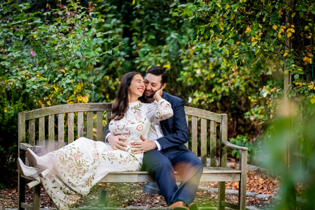 Authentic engagement photo capturing genuine laughter and intimate connection between couple in fall setting