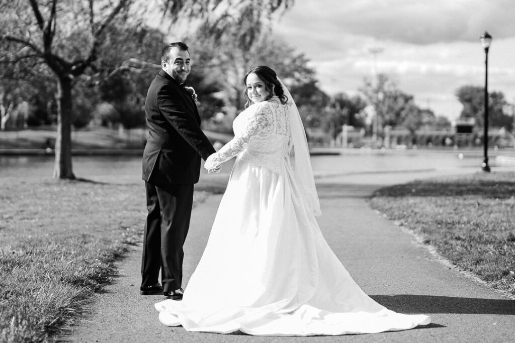Black and white of bride and groom gazing at each other on Lincoln Park pathway.