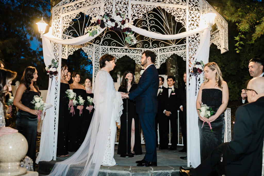 Evening ceremony under string lights at Cortlandt Colonial gazebo Hudson Valley wedding