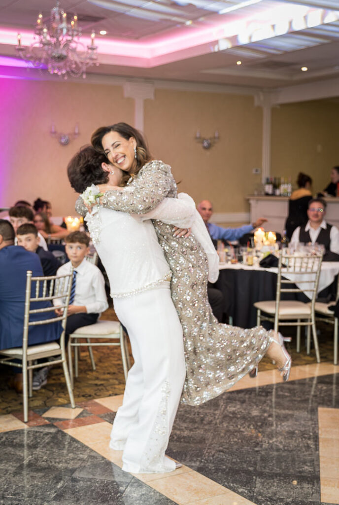 Parent dance moment with pink uplighting and chandelier Cortlandt Colonial Hudson Valley wedding