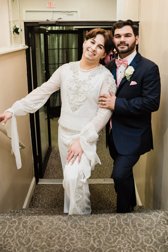Couple posing on staircase at Cortlandt Colonial Restaurant ballroom Hudson Valley wedding portrait