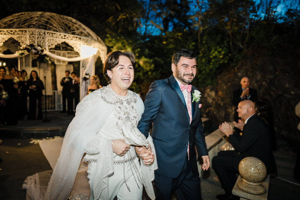 Couple beaming with joy walking down aisle after ceremony Cortlandt Colonial Hudson Valley wedding