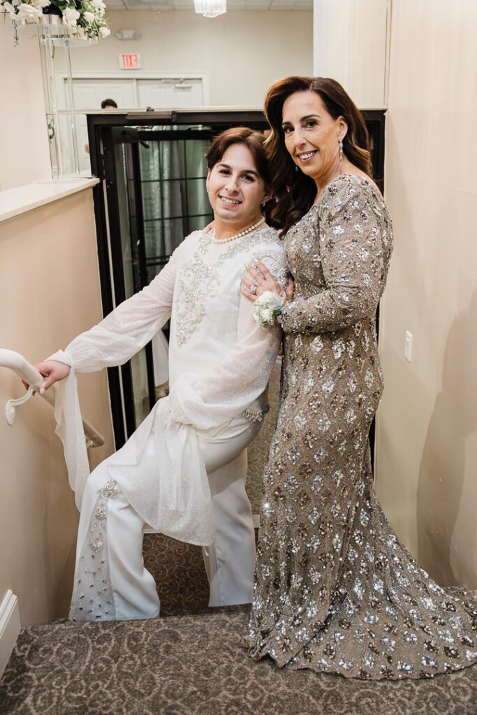 Bride embracing mother in champagne gown at Cortlandt Colonial reception Hudson Valley wedding