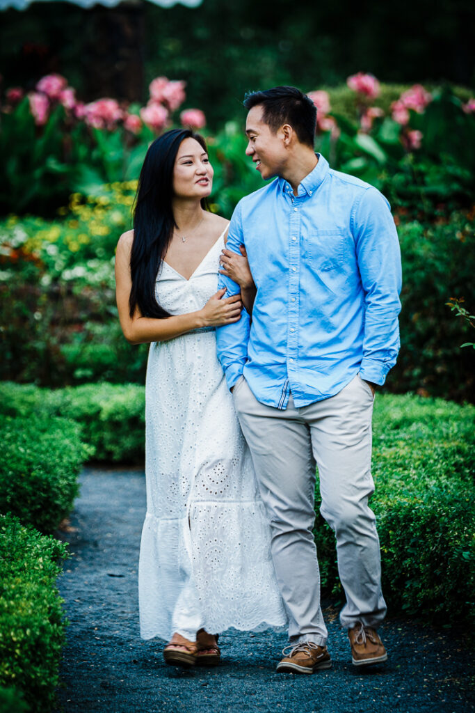 Couple in coordinated summer engagement outfits at Deep Cut Gardens Monmouth County
