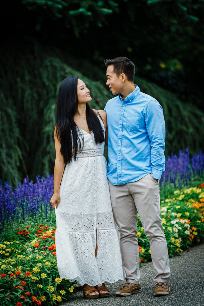 Engaged couple standing on garden path at Deep Cut Gardens in Middletown NJ