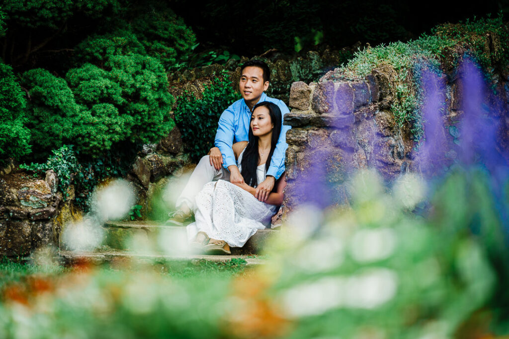 Couple embracing among purple and orange flowers at Deep Cut Gardens NJ