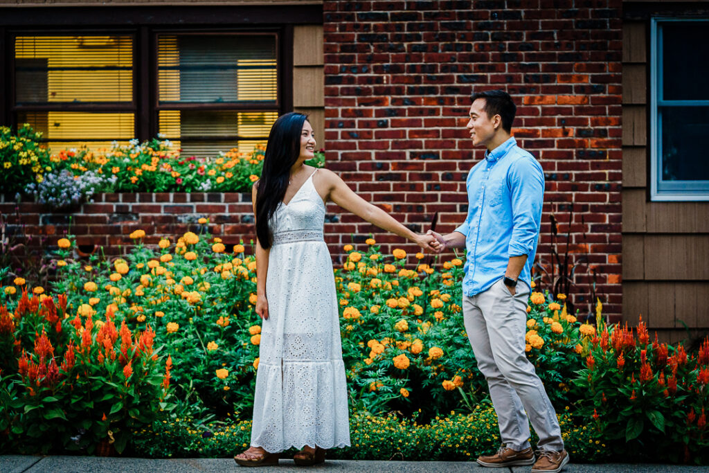 Couple near greenhouse building during Deep Cut Gardens engagement photoshoot