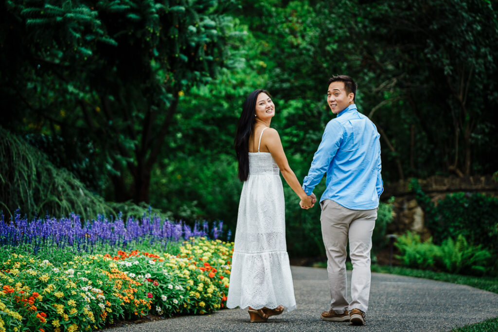 Couple in light blue and white outfits at Deep Cut Gardens engagement photoshoot