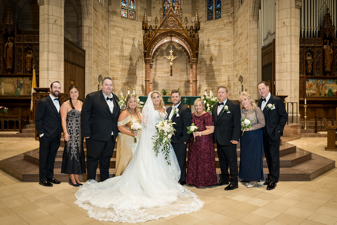 Full wedding family portrait inside Our Lady of Sorrows Catholic Church in South Orange NJ by Alex Kaplan Weddings