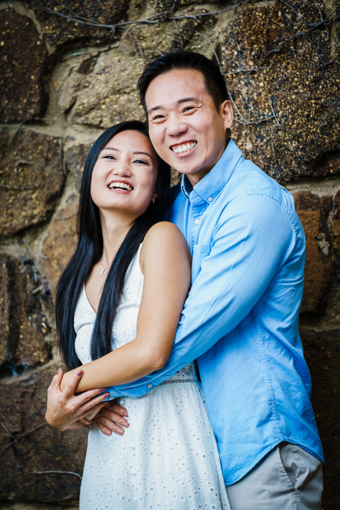 Joyful engaged couple on stone pathway at Deep Cut Gardens NJ