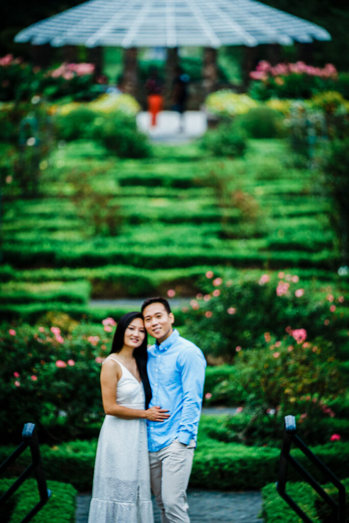 Moody engagement portrait at Deep Cut Gardens with architectural elements