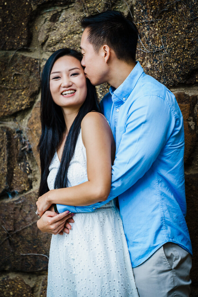Couple laughing together during candid engagement session at Deep Cut Gardens